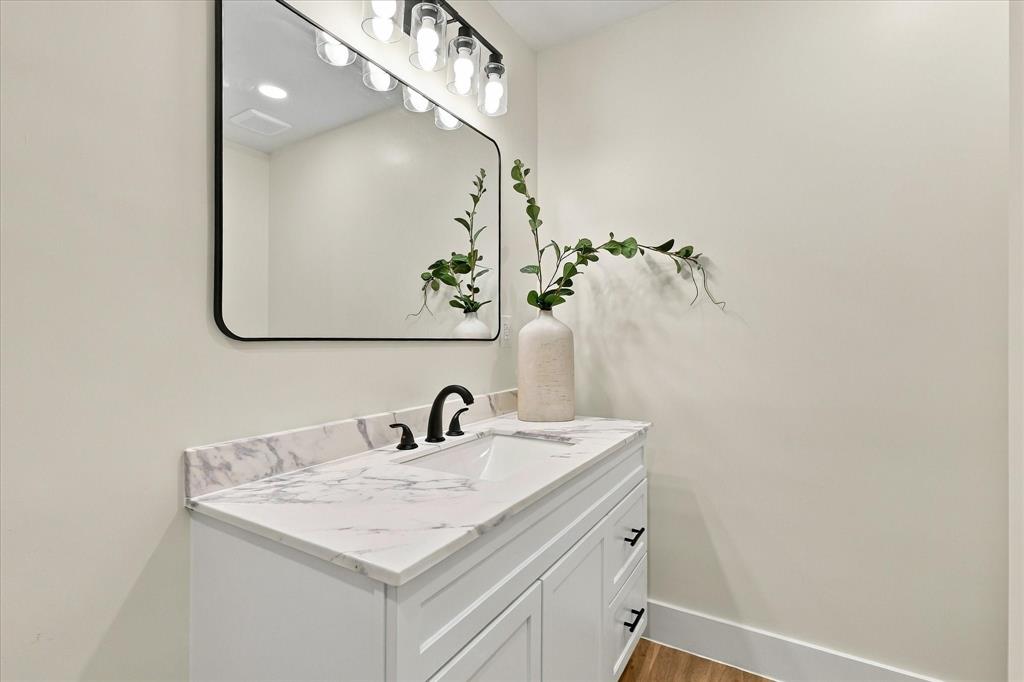 Secondary bath with brand new vanity and fixtures.