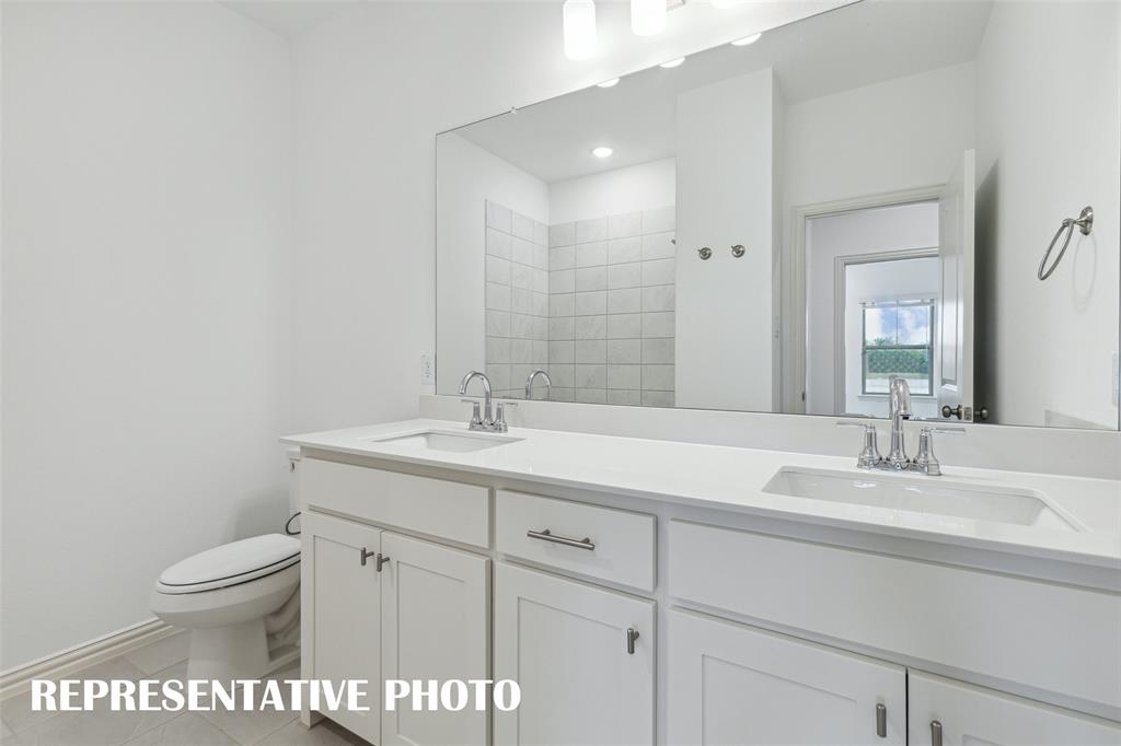 Guests will enjoy their own vanity space in this thoughtfully designed guest bath.  REPRESENTATIVE PHOTO