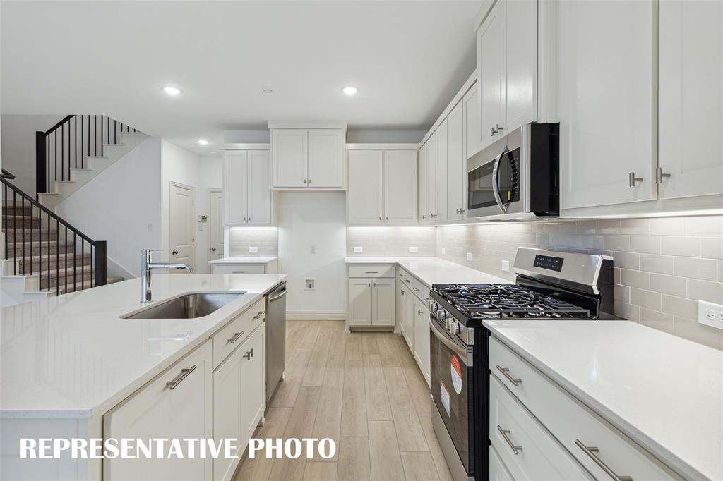 Beautiful cabinetry, gorgeous counter tops and classic backsplash effortlessly pair with contemporary stainless steel to create a kitchen for the ages!  REPRESENTATIVE PHOTO