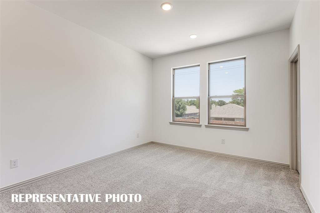 One of two spacious secondary bedrooms in our Tatum floor plan.  REPRESENTATIVE PHOTO.