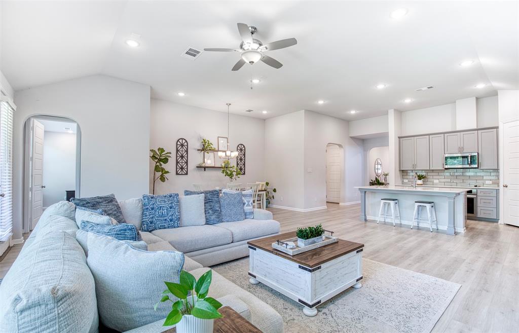 Seamless open-concept living flows effortlessly into the kitchen & dining areas, creating an inviting space for entertaining & gathering with family & friends.