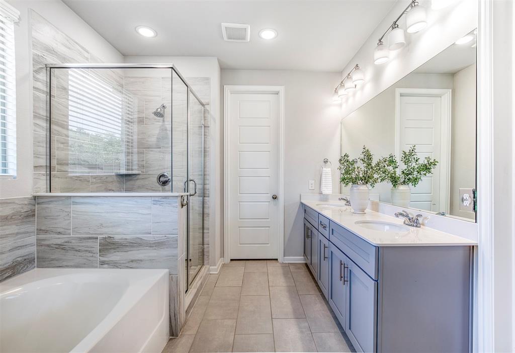 En-suite bath with dual sinks and walk-in closet.