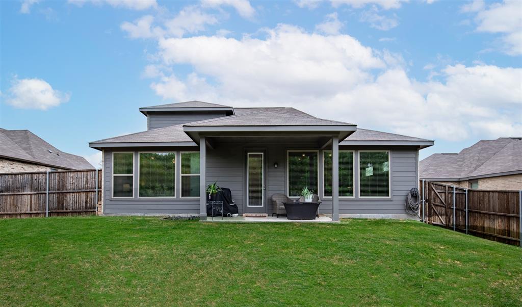 Covered patio with grassy yard.