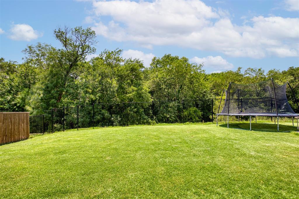 Backyard overlooks green space.