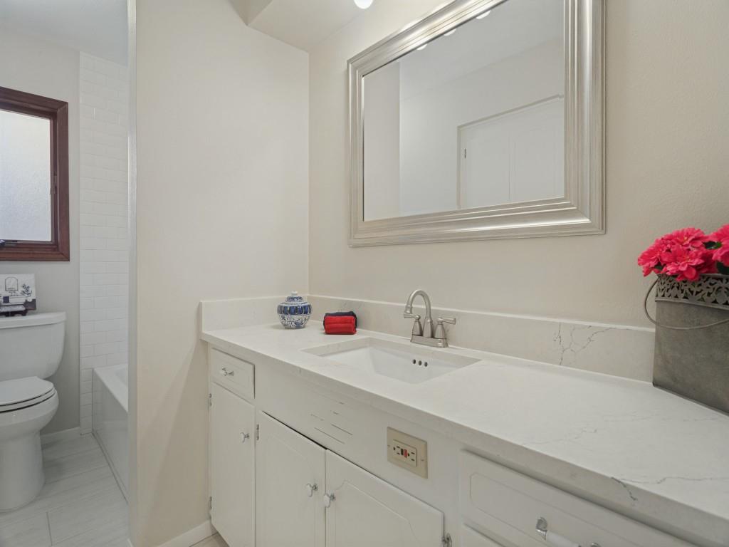 Updated  Hall Bath with stone counters & tons of storage