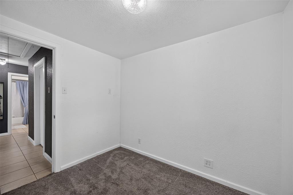 Neutral wall paint with textured finish, plush carpeting, and flush-mount ceiling lighting
