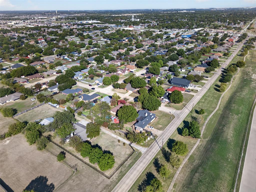 Aerial perspective featuring expansive lot sizes, mature tree canopy, and established neighborhood infrastructure
