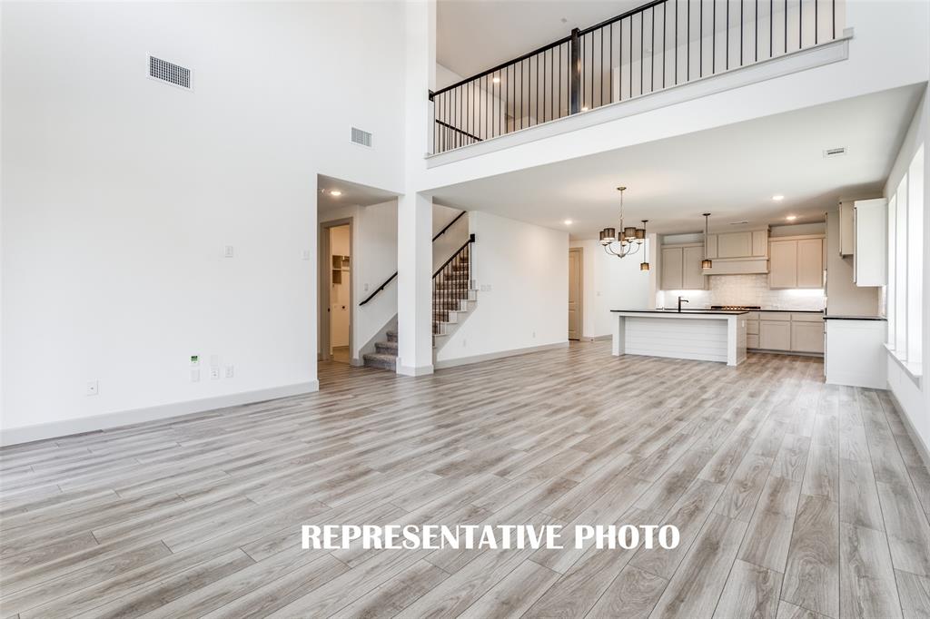 The family room is open to the game room upstairs creating multiple levels of open concept space for entertaining! REPRESENTATIVE PHOTO The family room is open to the game room upstairs creating multiple levels of open concept space for entertaining! REPRESENTATIVE PHOTO