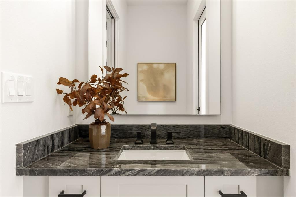 Powder bath directly off kitchen and accessible from back patio