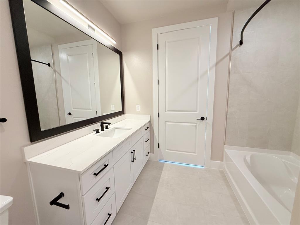 Full bathroom with vanity, tub / shower combination, and light tile patterned floors