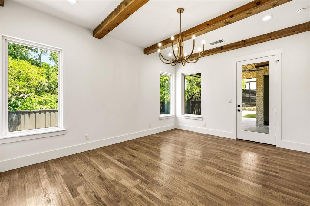 Wood beams, large windows and direct access to covered patio