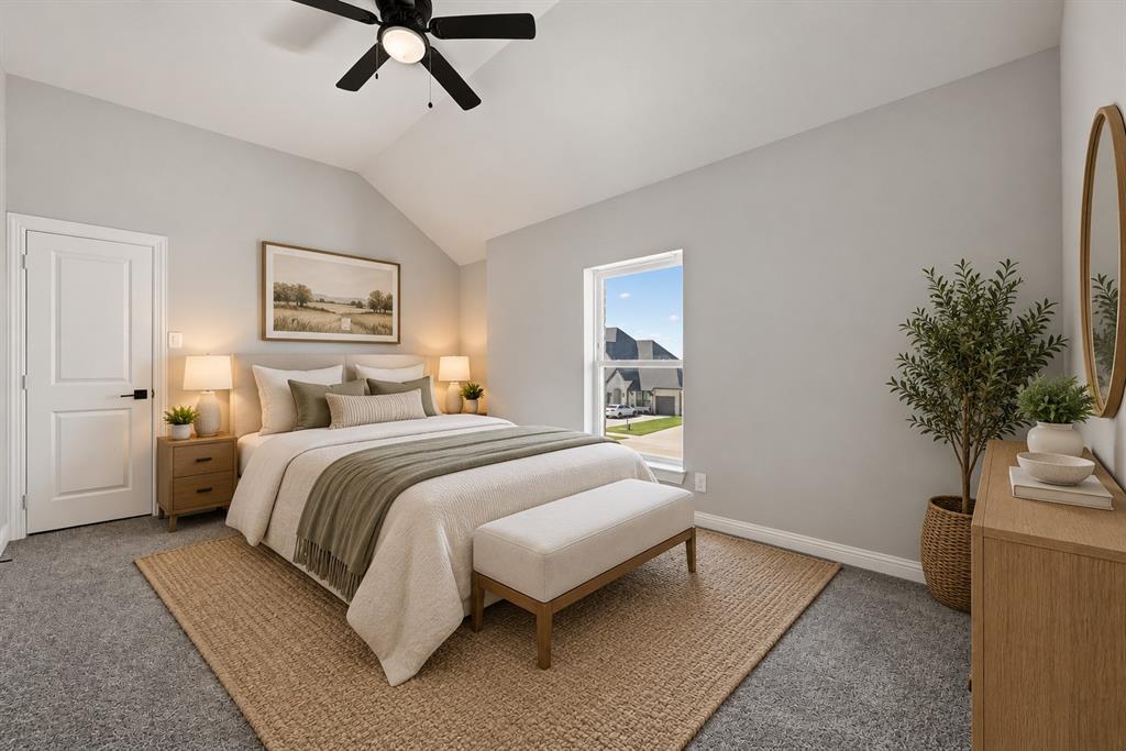 Vaulted ceiling with a matte black integrated ceiling fan, neutral wall tones, and crisp white paneled door