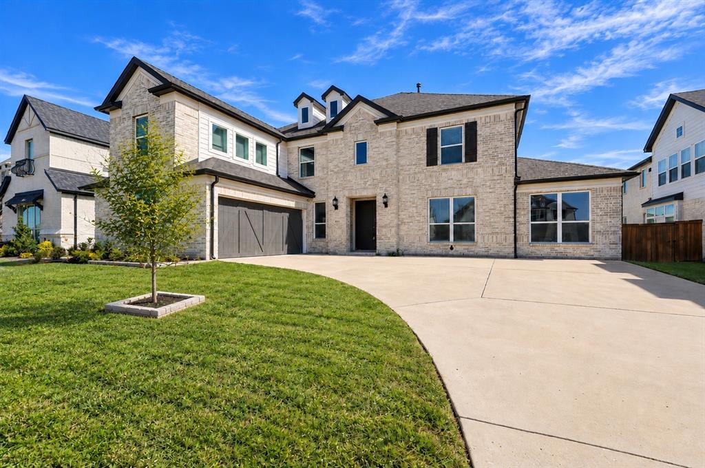 Two-story brick and siding exterior featuring a multi-gabled roofline, concrete driveway, attached multi-car garage, and dormer windows Two-story brick and siding exterior featuring a multi-gabled roofline, concrete driveway, attached multi-car garage, and dormer windows