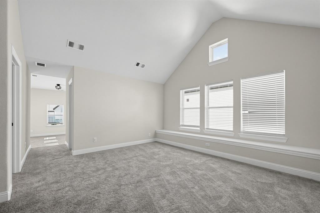 Vaulted ceiling featuring a clerestory window, integrated window bench, and wall-to-wall carpeting