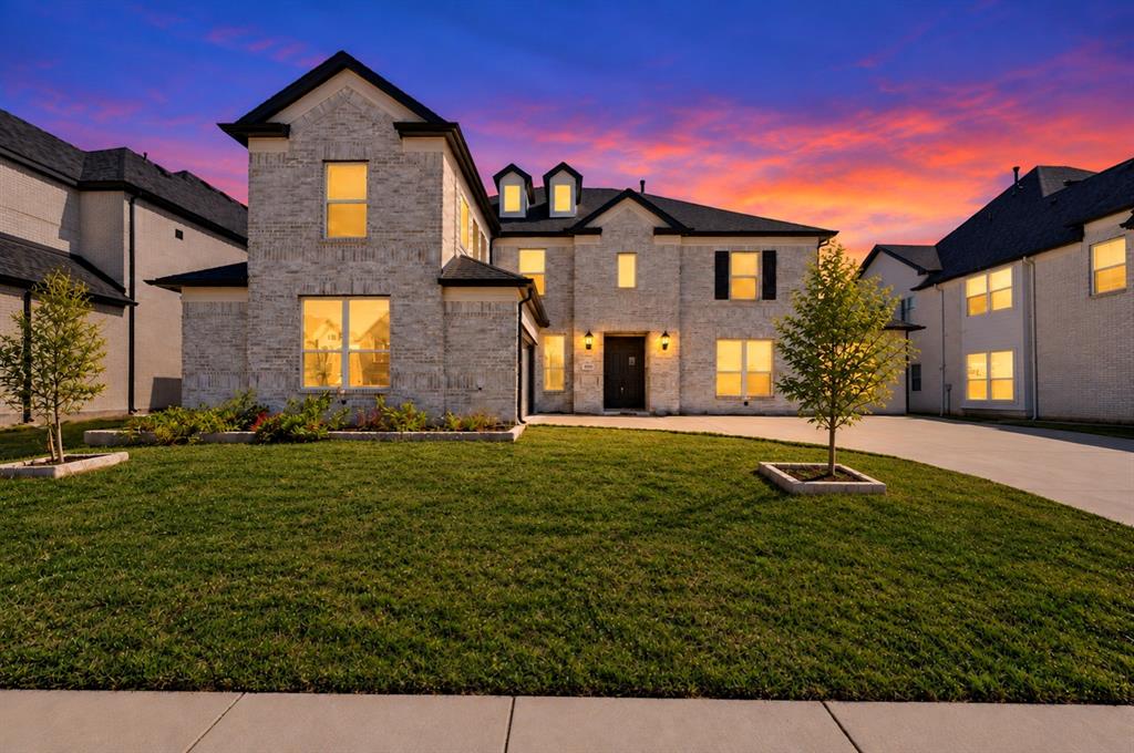 Multi-story brick exterior featuring a steep-pitched roofline, multi-pane windows, decorative dormers, and a paved concrete driveway Multi-story brick exterior featuring a steep-pitched roofline, multi-pane windows, decorative dormers, and a paved concrete driveway