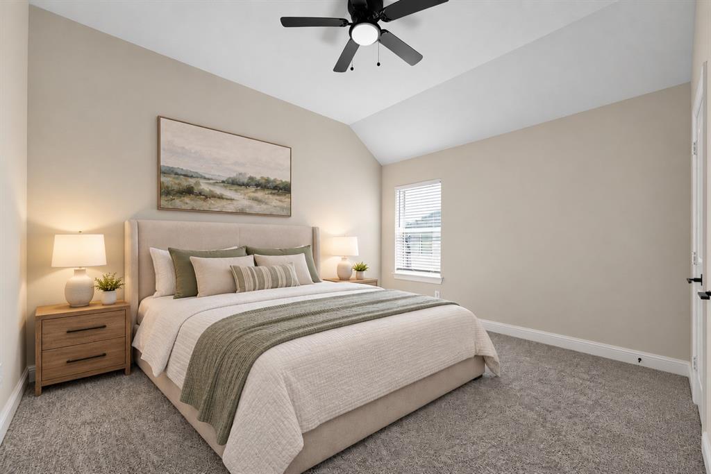Vaulted ceiling, neutral wall tones, plush wall-to-wall carpeting, and a black multi-blade ceiling fan with integrated lighting