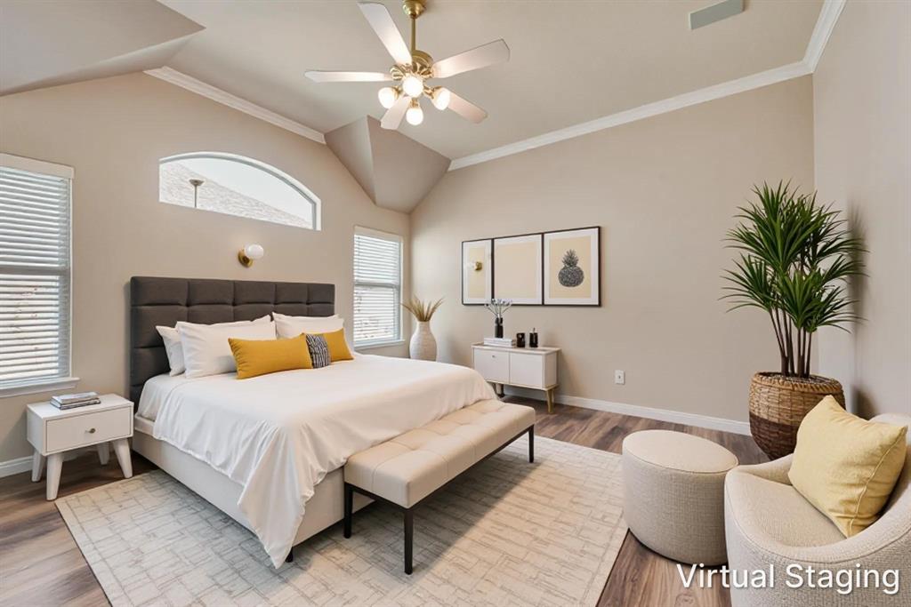 Vaulted ceiling with an integrated light-and-fan fixture, arched transom window, and wood-finish flooring