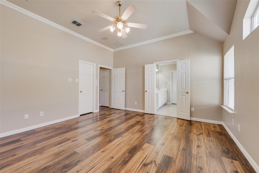Vaulted ceilings, wood-finish flooring, recessed lighting, and white six-panel interior doors