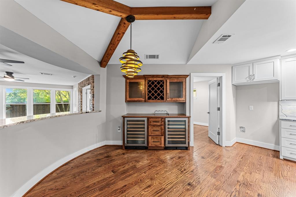 The breakfast area features a bar and exposed wooden beams.