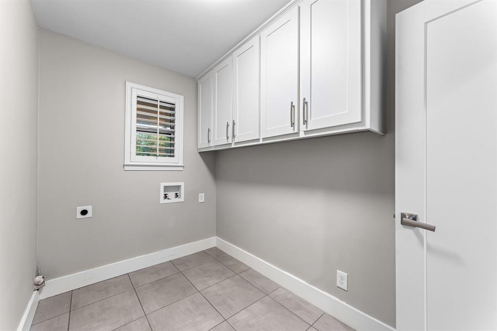 Laundry room featuring cabinets and full size washer and dryer connections.