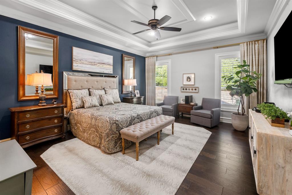 Tray ceiling with recessed lighting, dark wood-finish flooring, and crown molding