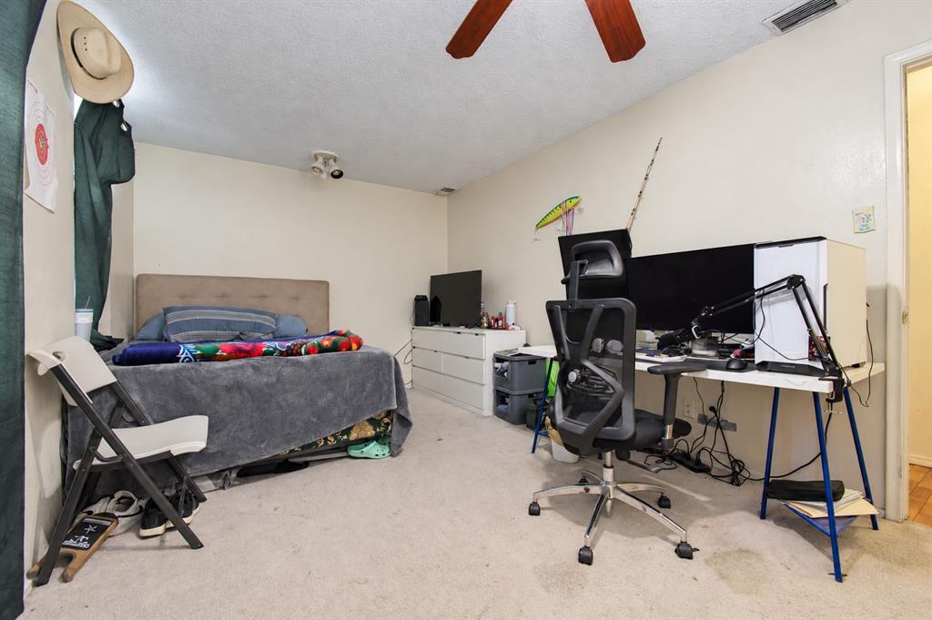 Bedroom featuring neutral wall paint, carpeting, and a ceiling fan
