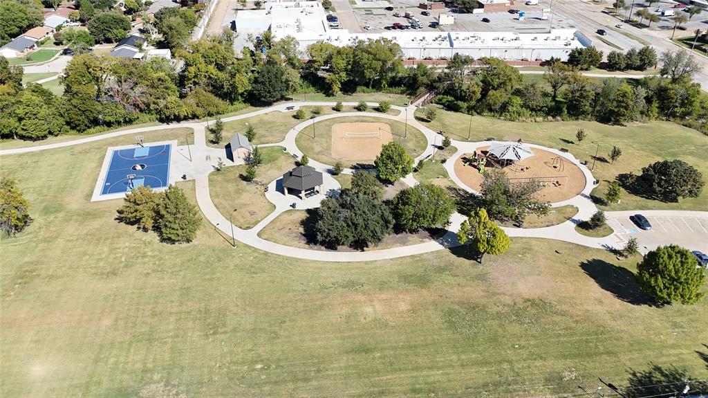 Public park featuring a basketball court, sand volleyball court, playground, gazebo, and paved walking paths