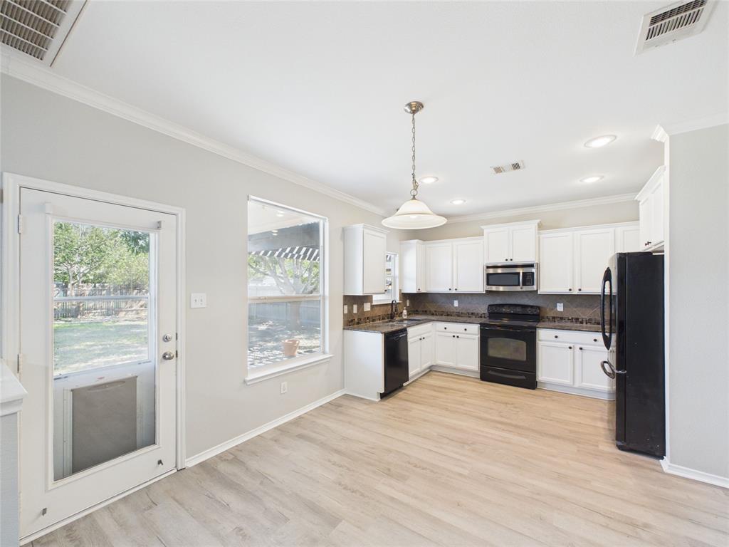 Kitchen featuring white cabinetry, wood-finish flooring, recessed lighting, a neutral-toned tile backsplash, and a pendant light fixture Kitchen featuring white cabinetry, wood-finish flooring, recessed lighting, a neutral-toned tile backsplash, and a pendant light fixture