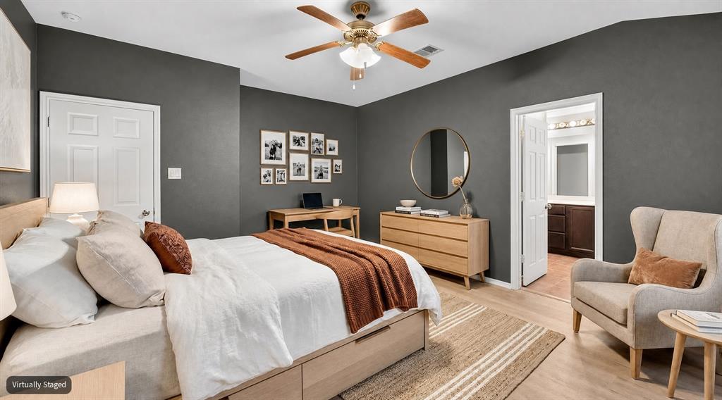 VIRTUALLY STAGED Interior space featuring neutral-toned walls, wood-finish flooring, and a ceiling fan with integrated lighting