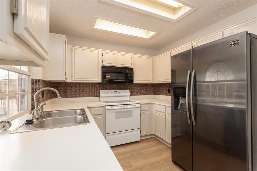 Freshly painted cabinets and updated flooring