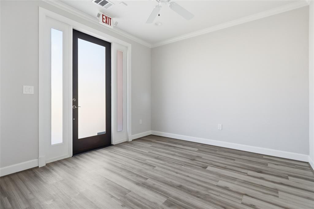 Entry room featuring wood-finish flooring, white crown molding, a ceiling fan, and an exterior door with dual glass sidelights Entry room featuring wood-finish flooring, white crown molding, a ceiling fan, and an exterior door with dual glass sidelights