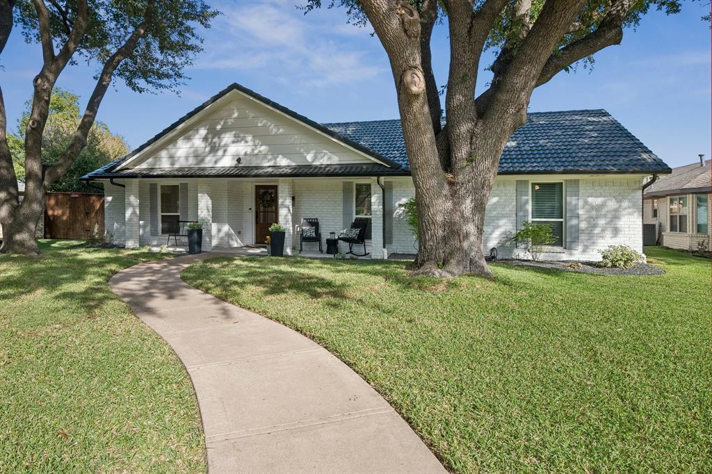 Set on a quiet street, unwind under a roomy front porch perfect for crisp mornings and evenings alike. Set on a quiet street, unwind under a roomy front porch perfect for crisp mornings and evenings alike.