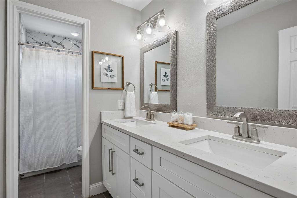 The hall bath provides a clean and bright aesthetic with quartz counters.