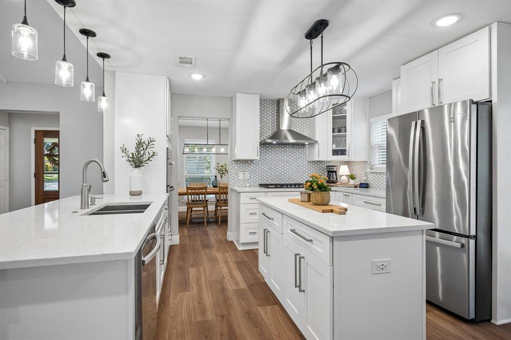 Beautiful and functional, this kitchen hosts sleek quartz counters and all stainless steel appliances.