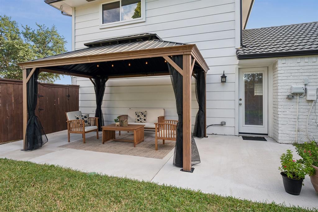 Delight in a shaded gazebo equipped with power and fans, plus an irrigation system covering all three lawn areas and flower beds.