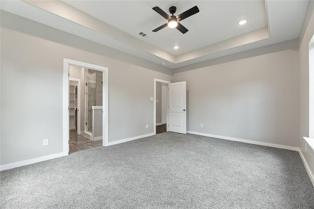 Tray ceiling featuring a central matte black ceiling fan, recessed lighting, and wall-to-wall carpeting