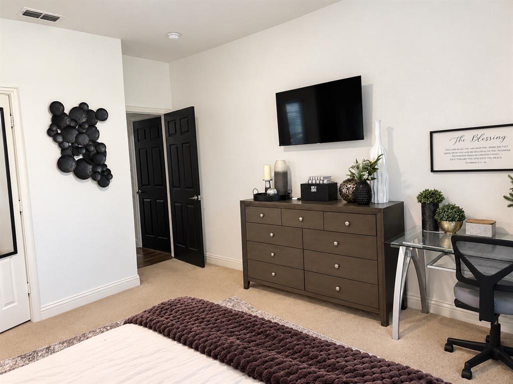 Interior space featuring high ceilings, wall-to-wall carpeting, and contrasting black six-panel interior doors