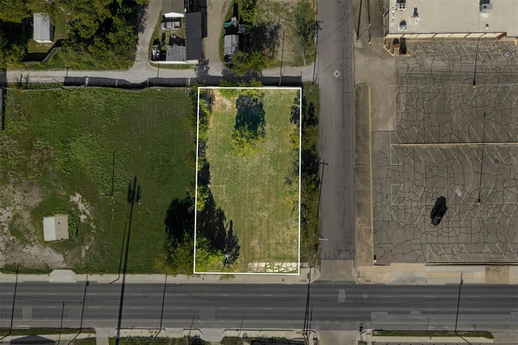 Cleared rectangular lot featuring mature perimeter trees and direct street access