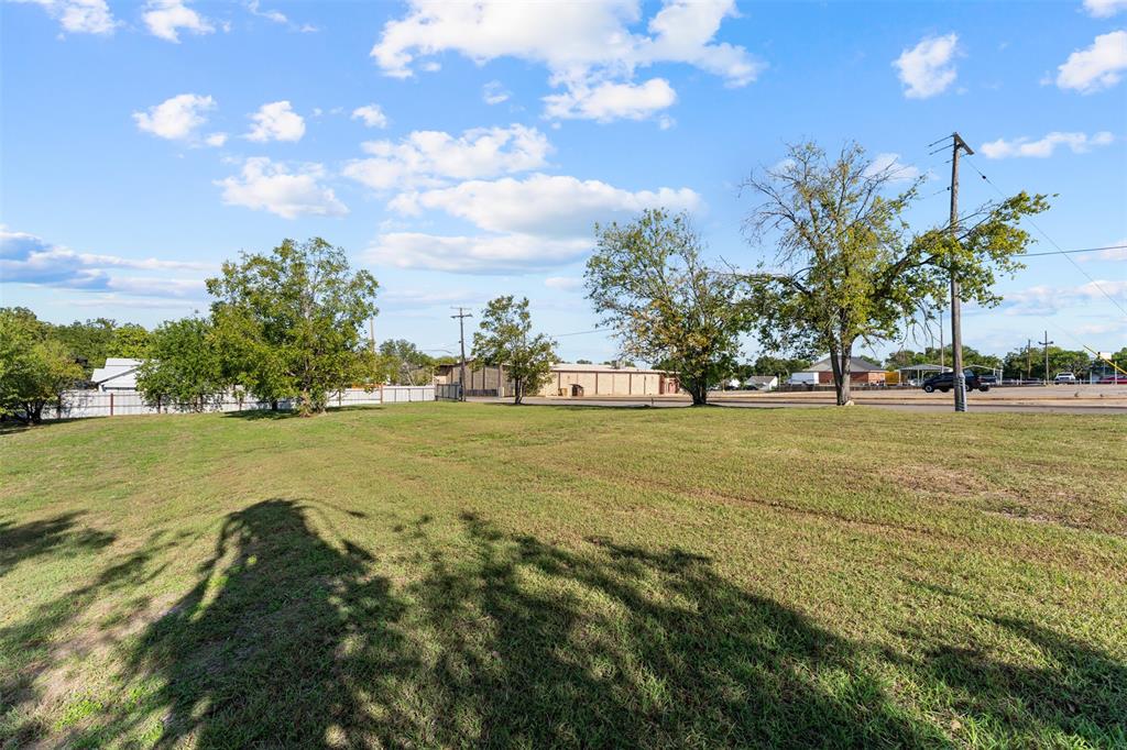 Expansive lot featuring mature trees and a clear, open lawn