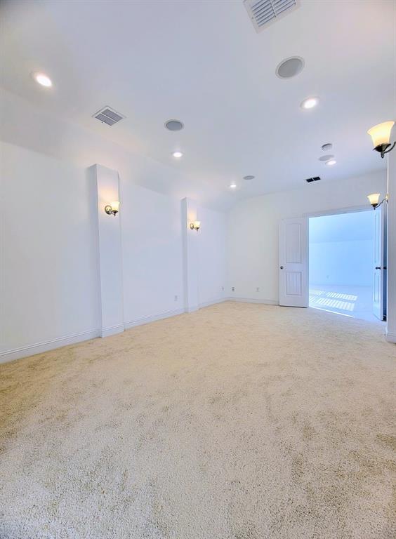 Neutral interior space featuring a brand new built-in surround sound system, recessed ceiling lighting, and double doors.