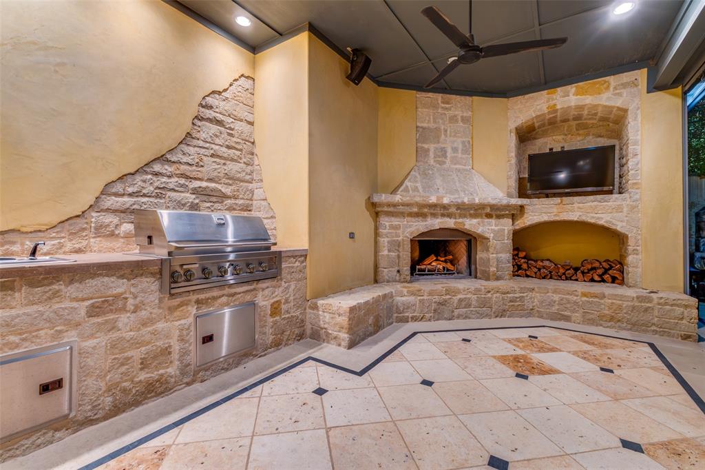 Outdoor kitchen, entertainment area with fireplace and screens