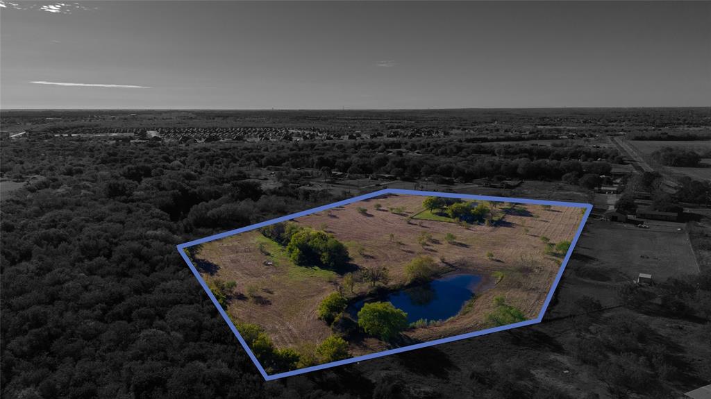 Expansive acreage featuring a private pond, open pasture, and mature trees