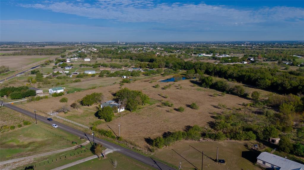 Expansive acreage featuring mature trees, a private pond, and frontage along a paved road