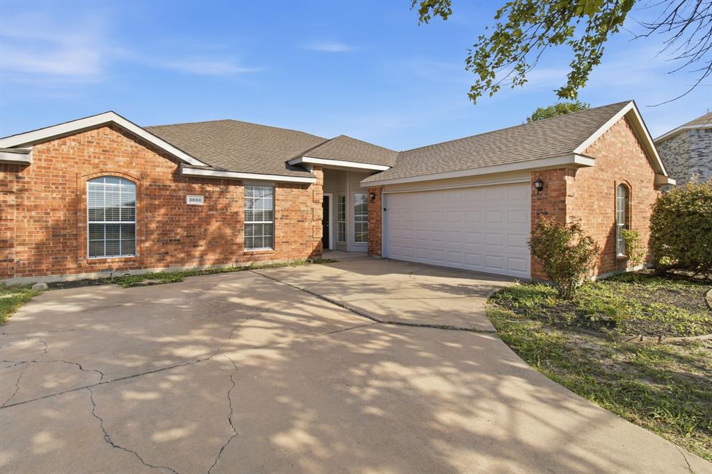 Single-story brick exterior featuring a multi-gabled roofline, concrete driveway, and attached two-car garage Single-story brick exterior featuring a multi-gabled roofline, concrete driveway, and attached two-car garage
