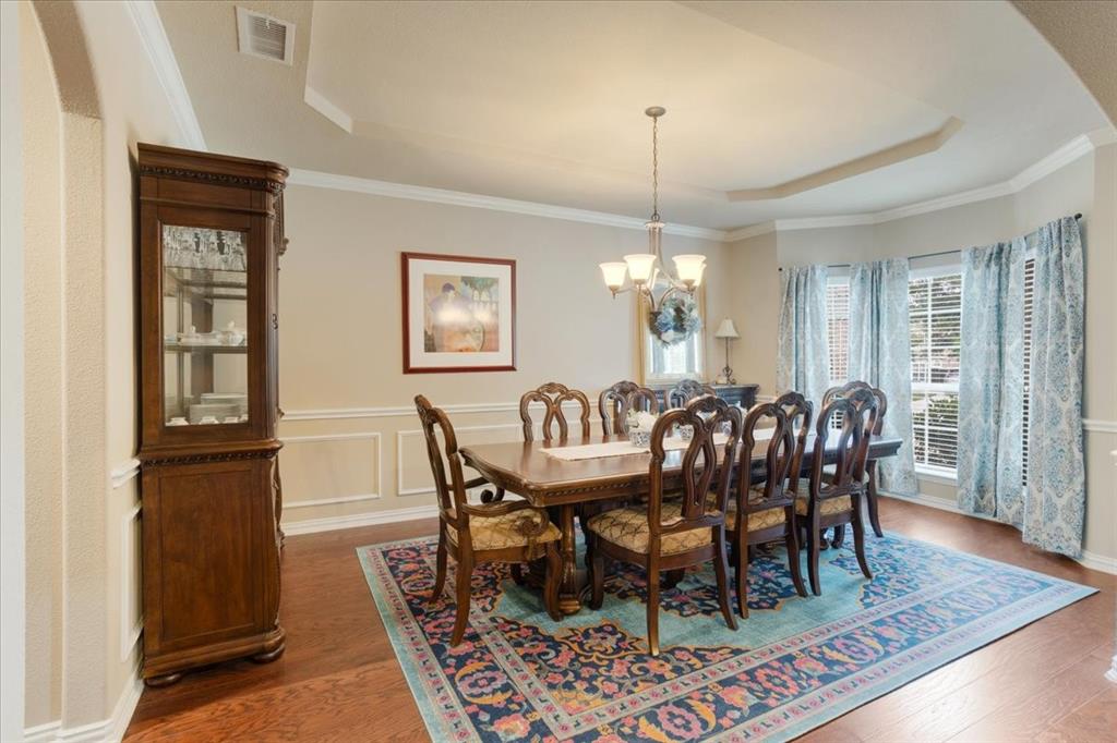 Formal dining area featuring rich wood-finish flooring