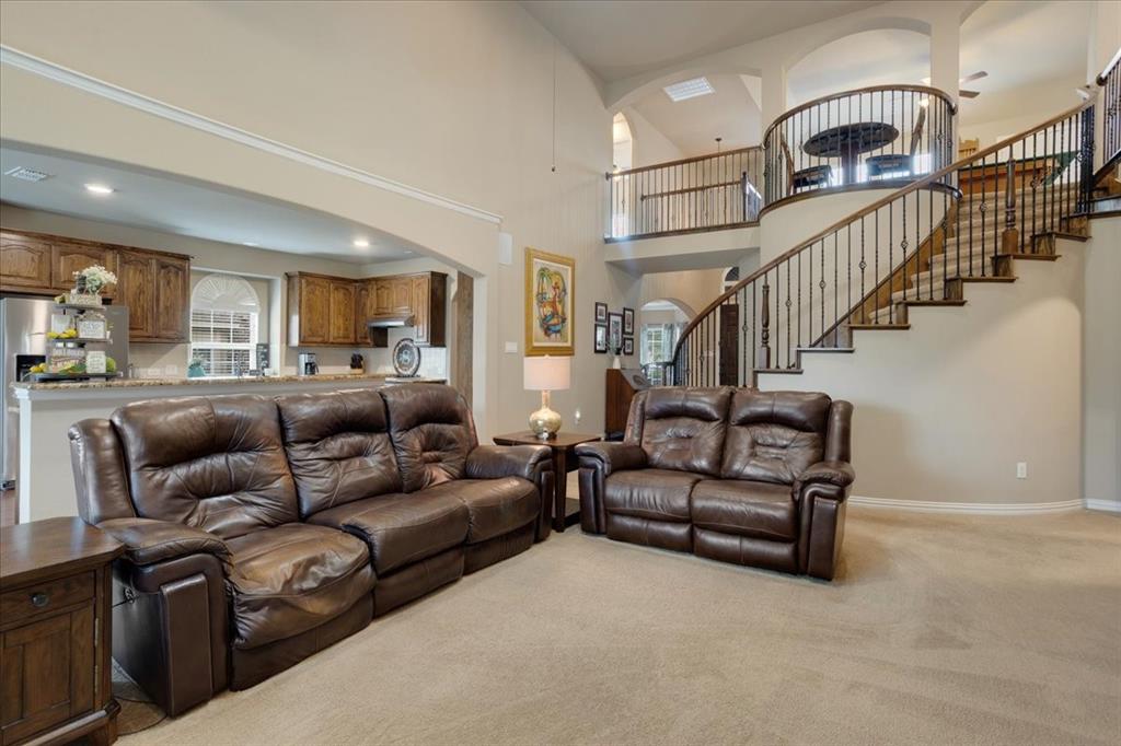 Grand foyer featuring a curved staircase with wrought iron balusters and wood handrails