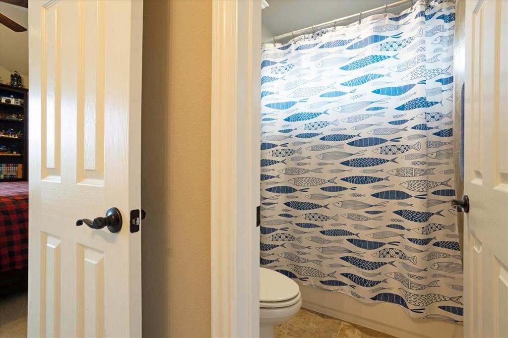 Bathroom entry with white paneled doors and dark bronze hardware