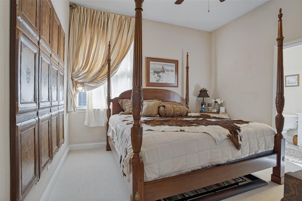 Neutral-toned carpeted flooring, wall-mounted decorative wood paneling, and a ceiling fan