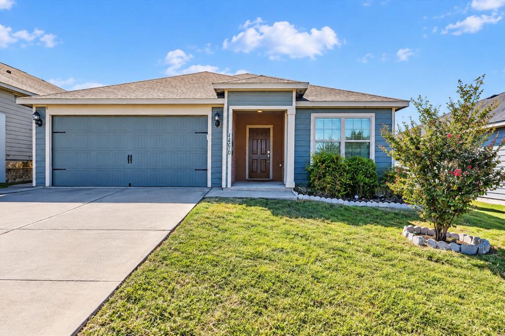 Single-story residence featuring blue horizontal lap siding, an attached two-car garage, an integrated front entry porch, and a concrete driveway