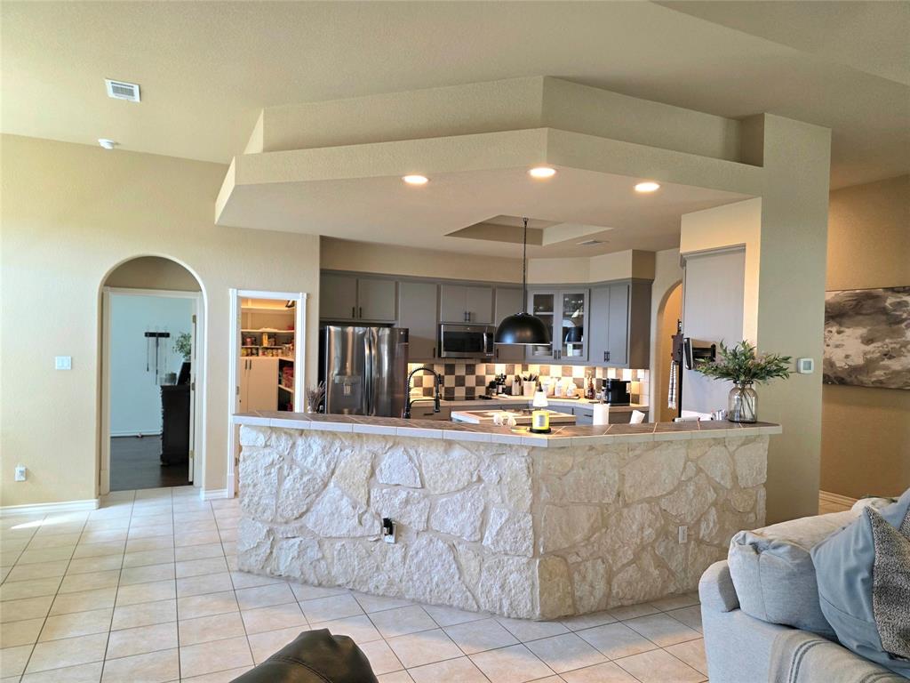 Completely functional kitchen with a great backsplash.